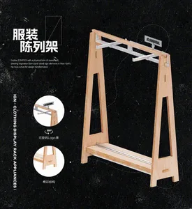 A modern wooden clothing display rack with a 360-degree rotatable logo sign and support function for retail or commercial env