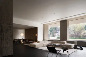 Modern living room with light concrete and minimalist furniture.
