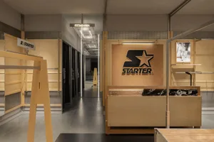 A retail clothing shop featuring wooden interiors and fixtures.