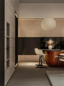 Modern kitchen with minimalist design featuring concrete walls and floor.