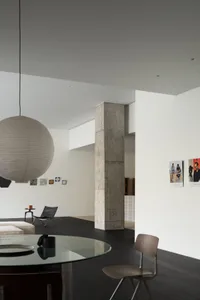 Modern living room with concrete columns and minimalist furniture.