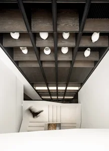 Modern minimalist staircase with wooden steps and metal railings.