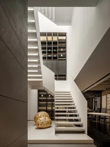 A modern residential staircase with concrete steps and marble accents.