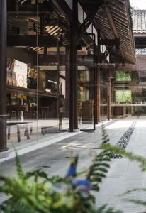 A modern retail storefront featuring large glass windows and wooden structures.
