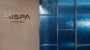 The entrance to a spa interior featuring blue textured tiles.