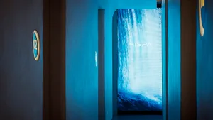 Spa entrance with a glass wall featuring a cascading waterfall.