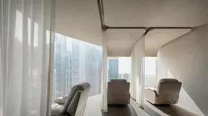 Contemporary seating area featuring modern leather chairs and glass panels.