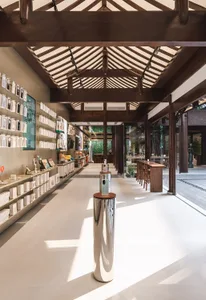 A minimalist retail storefront with metal columns and white flooring, featuring a modern interior design.