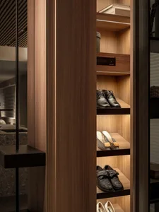 Well-organized closet shelves with shoes and other items.