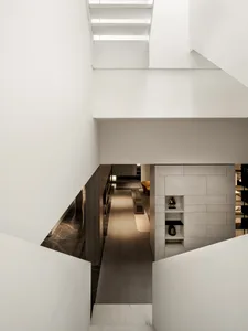 Modern residential interior featuring a sleek, minimalist staircase made of concrete.