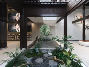 A modern storefront with an indoor garden featuring a wooden frame, glass walls, and a natural rock garden.