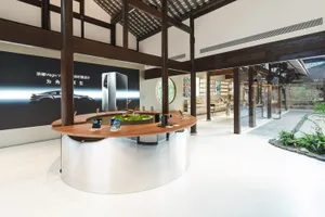 A retail store featuring a modern interior with wooden elements, glass displays, and concrete flooring.