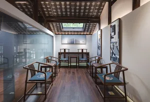 A traditional Chinese living space featuring wooden furniture and a skylight.
