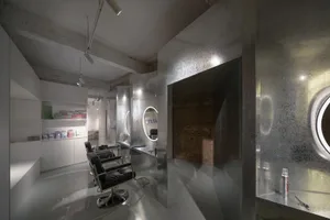 Modern salon interior with metallic design elements and sleek white surfaces.