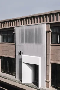 Modern storefront with large glass curtain wall, minimalistic design.