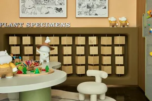 A modern minimalist toy room with wooden blocks and toys displayed on a table and chair.