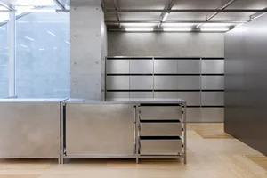 A minimalist interior design featuring metal cabinets and drawers.