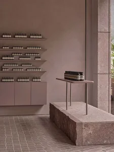 Minimalist retail storefront with concrete walls and shelves.