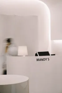 A minimalist spa reception desk made of white marble, featuring a sleek, modern design with clean lines and a simple, elegant