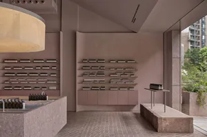 Modern interior design featuring a store front with natural stone and concrete.