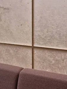A close-up view of modern interior wall tiles made of paper, showcasing their textured surface and natural fibers.