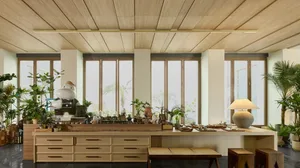 A minimalist living room featuring wooden furniture and decor.