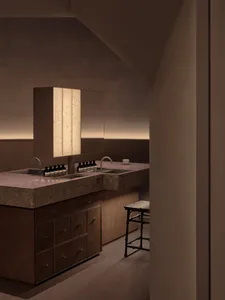 Minimalist bathroom with concrete countertops and industrial lighting.