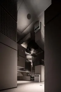 Modern office space featuring industrial, minimalist design with concrete walls and floor.