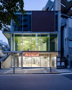 Modern retail storefront with a glass facade, open storefront display, and urban street view.