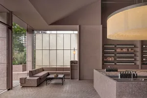 A minimalist retail storefront featuring concrete materials and a sleek, modern design.
