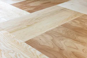 A patterned hardwood floor showcasing various shades of natural wood