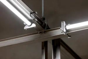 Steel beams and fluorescent light fixtures in an industrial setting