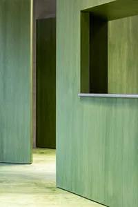 A minimalist interior space with concrete walls and floors, featuring a modern design aesthetic.