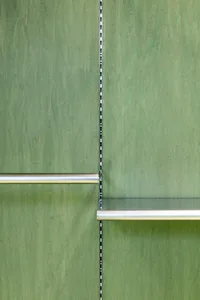 A modern green wall with metallic silver rails