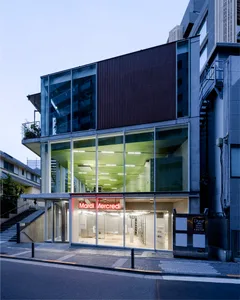 A modern storefront with a glass exterior during dusk