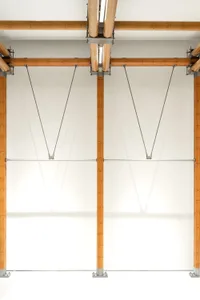 A modern interior design featuring wooden structural elements and lighting.