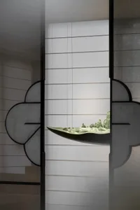 Ceramic wall art featuring mountain landscape displayed on a white wall with horizontal lines.