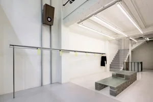 A minimalist commercial space featuring a metallic architectural design element.