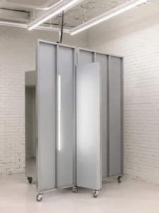 A minimalist metal installation featuring translucent panels and a neon light strip.