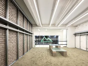 A modern office space featuring concrete flooring and walls.