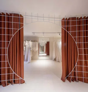 Retail storefront with fabric walls and metal frames in a metaverse setting.