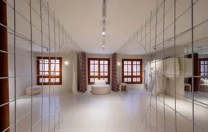 A minimalist fashion boutique featuring metal elements and a white floor.