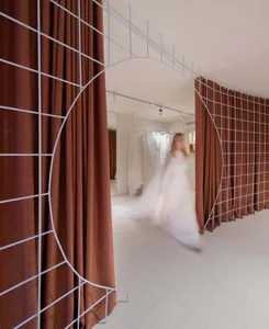 A modern clothing retail shop featuring metal structures and fabric walls