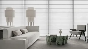 A modern living room featuring a white sofa with green marble coffee table and floor lamps.