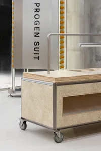 A modern metal furniture cart with a wooden top and wheels.