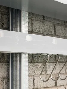Modern metal hooks mounted on a white background