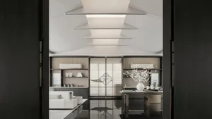 A modern office space featuring glass walls and sleek, minimalist furniture.