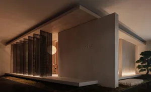 A modern residential entryway featuring a concrete grid system and a bonsai tree.