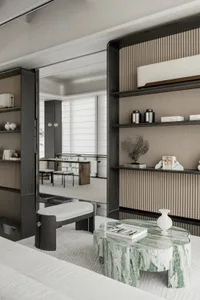 A modern residential interior featuring a marble coffee table, contemporary furniture, and minimalist decor.