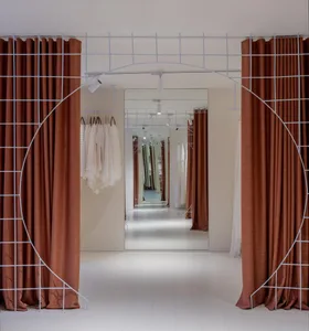 A modern retail interior designed for a clothing store, featuring fabric and metal materials, with an open space layout and c